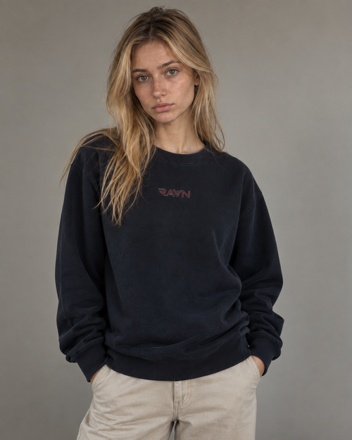 Woman wearing the Saga Crewneck in navy