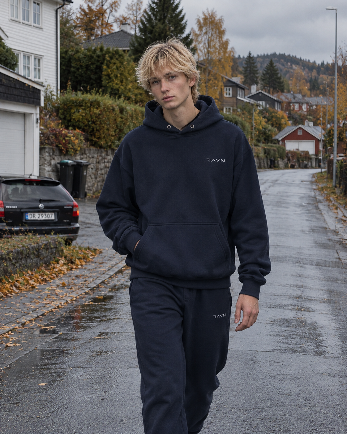 Male model wearing Ravn Nordic navy sweatwear on an autumn street