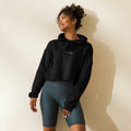 Woman wearing the Wren Cropped Hoodie in night black